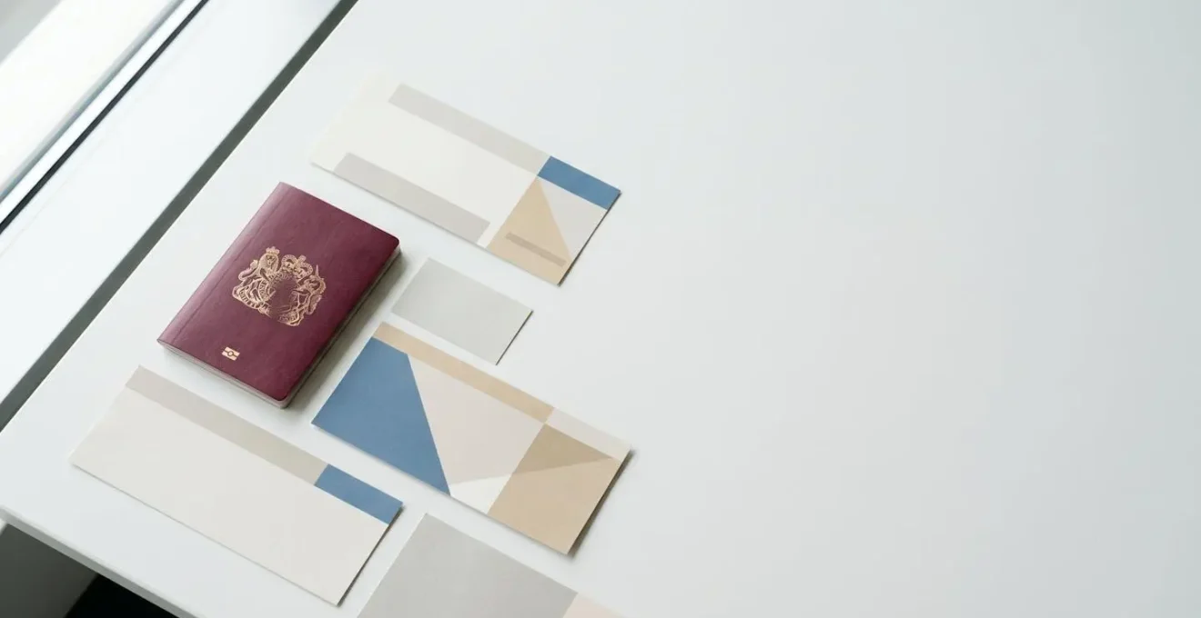 Travel documents arrangement showing passport and boarding materials in minimalist composition, editorial style