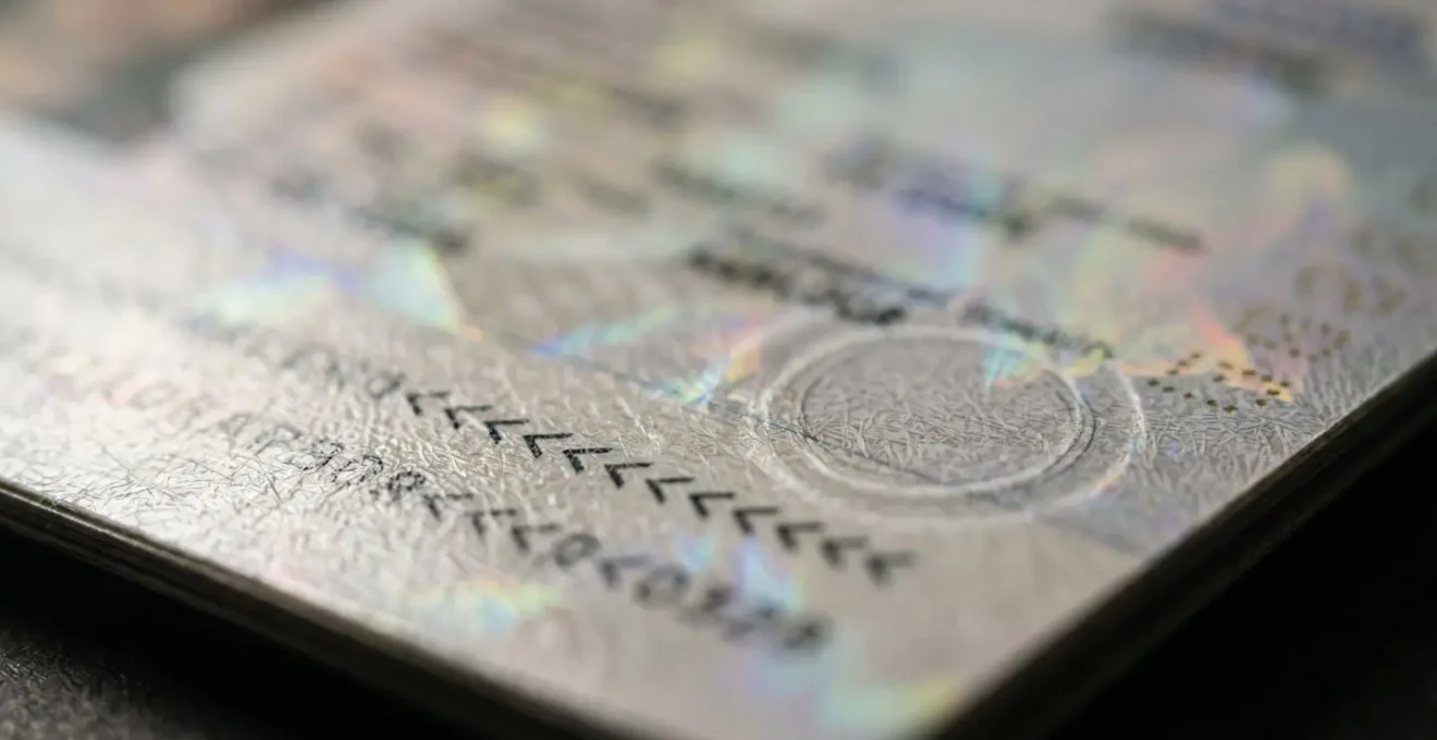 Extreme macro photograph of passport bio-data page showing machine-readable zone texture and chip location